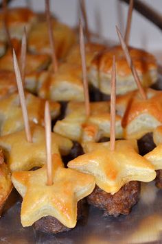 some food that is sitting on top of a plate with toothpicks in it