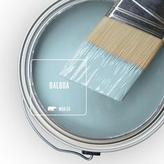 a paint can with a brush in it and the words watery on top of it