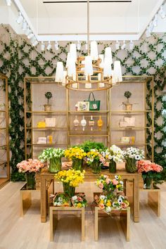 a flower shop with many different types of flowers in vases on tables and shelves