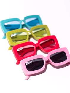 four pairs of sunglasses sitting on top of each other