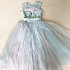 "Hands down one of the sweetest and coolest party dresses ever! That ice blue is just ❄️❄️❄️ And let's talk about that neckline! A X-front which ends in a nipped in waist. The metallic speckled material makes it that much more special. Full full full circle skirt done in silk, tulle and organza. Sooooooooooooo perfect! Condition: Very good. Slight yellow patch on back bodice which is barely noticeable. See second last photo. Fully lined. Bust 31\" Waist 24\" Length 44\" This item is clean and re Pastel Dresses For Spring Party, Light Blue Fitted Dress For Party Season, Pastel Sleeveless Dress For Party, Pastel Sleeveless Party Dress, Fitted Light Blue Dress For Party Season, Light Blue Sleeveless Cocktail Dress, Fitted Pastel Dress For Spring, Chic Fitted Pastel Dresses, Elegant Fitted Pastel Dresses