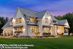 a large white house sitting on top of a lush green field