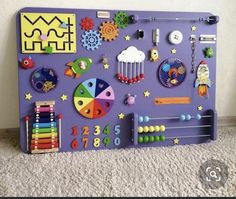 a child's play area with toys and magnets on the wall in front of it