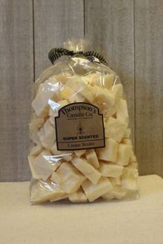 a bag of sliced cheese sitting on top of a white counter next to a wooden wall