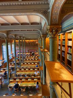 the interior of a library with tables and bookshelves