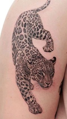 a woman's thigh with a tattoo of a leopard on it