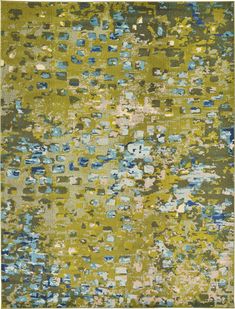 an area rug with many different colors and patterns on the surface, including green, blue,