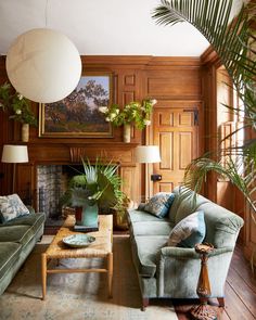 a living room filled with furniture and plants