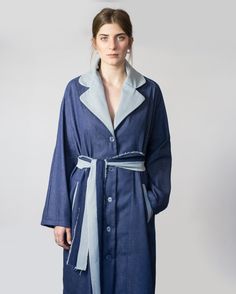 "Offers a city-ready style, Our favorite Denim in the collection - The Denim Trench. The style comes in two-tone blue Denim, Indigo Blue & washed LightBlue. Made & Crafted featuring buttoned front with transparent buttons, contrast notched lapels (in light blue denim), long wide sleeves, detachable sleeve straps in light blue denim with buttons on wrist for tightening the sleeves at the bottom, two front roomy functional pockets (in light blue denim), deep back yoke that finish with frayed detai White Kimono Dress, 70s Pants, Blue Winter Coat, Denim Coat Women, Denim Trench Coat, Blue Trench Coat, Winter Trench Coat, Blue Belt, Blue Winter