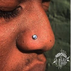 a close up of a man's nose with a piercing on it and the bottom part of his nose