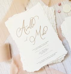 the wedding stationery is laid out on top of each other