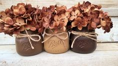 three mason jars with flowers in them tied to twine and labeled bill's