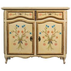 an old dresser with flowers painted on the front and side panels, all in different colors