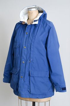 "80s Woolrich Parka Blue Hooded Mountaineer Anorak Parka Womens Jacket This vintage mountain parka is in good vintage condition. Few light little stains here and there, shows normal signs of wear. Royal blue cotton blend outer shell with lightweight tan liner. Four front pockets, with heavy duty YKK zip up front and brass snap closures. Leather toggles. Woolrich Woman. Size has been faded, fits like a large, please refer to measurements. Measurements shoulders: free chest: 48\" underarm to sleev Woolrich Parka, Parka, Royal Blue, Heavy Duty, Cotton Blend, Blue