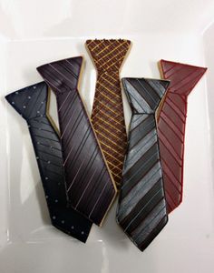 three decorated ties are sitting on a plate