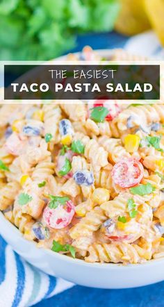 the best taco pasta salad in a white bowl on top of a blue and white towel