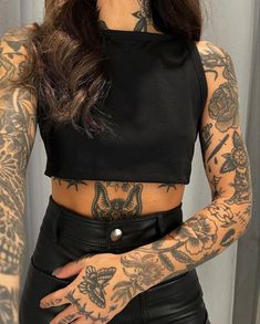 a woman with tattoos on her arms and chest