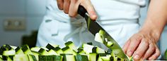 a person cutting up cucumbers with a knife