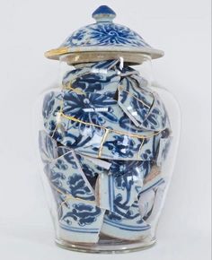 a blue and white vase sitting on top of a table