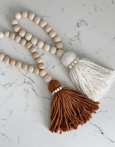 the tasseled beaded necklace is made from wood beads, and has a tassel