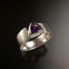 "Amethyst trillion-cut stone is a beautiful deep purple color. This is a beautiful well cut natural stone that is eye-clean. Stone measures 7x7 mm. Cold forged tapered band is 6mm wide and 2mm thick at the bottom and 7mm wide by 1.5mm thick at the top. The pictured ring is size 9 1/2 for scale reference. Specify your ring size in a \"note to seller\" at check-out." Modern Amethyst Ring With Accent Stones For Wedding, Modern Amethyst Wedding Ring With Accent Stones, Modern Amethyst Ring For Wedding, Modern Amethyst Wedding Ring, Trillion Cut Ring, Scale Reference, Ethiopian Opal Necklace, Triangle Ring, Wax Carving