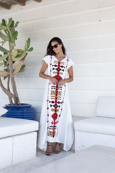 *Note : The kaftan in the video is a different color and is only displayed to show the fit, flow, and cut of the Kaftan. You will receive the one in the pictures.* This beautiful Kaftan with the Siwa inspired embroidery is a bohemian and flashy dress that will catch everyone's eyes. The kaftan has a bell shaped cut to it from the bottom which gives it a nice and unique flow. This Kaftan is ideal to wear for any casual occasion. Whether taking a trip down the shopping lane, or home-based kitty pa White Boho Print V-neck Maxi Dress, White Bohemian V-neck Dress, White Free Size Maxi Dress For Beach Cover-up, Traditional White V-neck Maxi Dress, Traditional White Long Kaftan, White V-neck Embroidered Dress For Festival, Cotton Folk Style Maxi Dress, White Boho Print Short Sleeve Dress, White Folk Dress For Eid