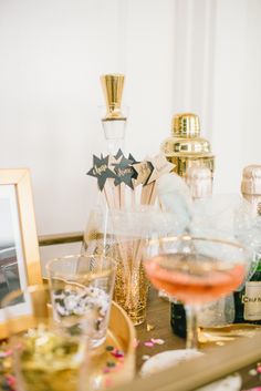 a table topped with champagne glasses and bottles