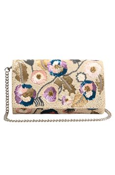 Expertly crafted in India, the Lolita Clutch is a true statement piece. Made from hand-woven jacquard, this fold over flap clutch features a shoulder strap in chain for versatile wear. The fully embellished design is complete with a magnetic button closure and lined interiors with a zip pocket. Elevate any outfit with this beautifully made accessory. 9.5 W x 6 L x 2.5 H Elegant Embroidered Clutch For Summer, Elegant Multicolor Clutch With Detachable Strap, Multicolor Clutch For Evening In Spring, Embroidered Clutch For Evening In Summer, Multicolor Evening Clutch With Detachable Strap, Evening Multicolor Clutch With Detachable Strap, Spring Evening Clutch Embroidered, Woven Clutch For Evening, Spring Evening Embroidered Clutch