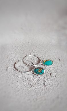 This minimal  dangle sterling silver turquoise earrings are handmade and unique. Because of this there may be a small difference in each piece.  I used sterling silver (925k), sterling silver hoops and green turquoise gemstone with silver smithing technique. This charming turquoise boho earrings are suitable for daily use in summer days . Also this healing gemstone earrings can be a stylish gift alternative for capricorns. Radius of hoop earrings is 2 cm. Dimensions of  turquoise gemstone 0,7 cm Silver Smithing, Sterling Silver Turquoise Earrings, Silver Turquoise Earrings, Gemstone Hoop Earrings, Turquoise Earrings Dangle, Minimal Earrings, Turquoise Boho, Silver Dangle Earrings, Sterling Silver Dangle Earrings