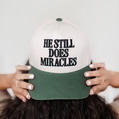 Inspire with Style: The "He Still Does Miracles" hat is a stylish and versatile cap that is more than just an accessory; it's a statement of belief and a reminder that God is the God of miracles. Features:  * High-Quality Material: Made from premium cotton, ensuring comfort and    durability. This hat is perfect for all-day wear, whether you're out and    about or relaxing at home.  * Adjustable Fit: Equipped with an adjustable strap, this hat fits most head    sizes comfortably, providing a secure and snug fit for both men and women.  * Inspirational Design: The bold "He Still Does Miracles" embroidery stands    out, making it a powerful testament to your faith and a conversation starter    wherever you go. Why You'll Love It:  * Faith Affirmation: Carry a daily reminder of your faith and God Of Miracles, Sarcastic Clothing, Christian Hats, Hat Fits, Faith Gifts, Planner Accessories, Square Earrings, Cute Hats, Unique Christmas