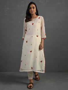 A straight-cut kurta in cotton silk fabric with all-over floral buttis made using beads, sequins and silk French knots. Kurta, pants and dupatta have a lace edging at the hem, side cut, and sleeve ends. Bead work runs along the neckline and in between lace patterns. Delicate pin tucks stitched across the organza dupatta with embroidered scalloped edges and machine stitches in between pin tucks. Elasticated waist comfortable fully lined pants with draw strings. Kurta measurements (in Inches): Siz Slub Silk Churidar With Floral Embroidery, Off White Cotton Anarkali Set With Sheer Dupatta, Traditional Off-white Anarkali Set With Printed Motifs, Off White Palazzo Set With Resham Embroidery, Off White Cotton Sets With Sheer Dupatta, Cream Chanderi Kurta With Printed Motifs, Off White Chanderi Straight Kurta Set, Traditional Off White Anarkali Set With Printed Motifs, Off White Cotton Silk Sets With Resham Embroidery