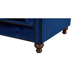 an upholstered blue velvet bed frame with studded trimmings and wooden feet