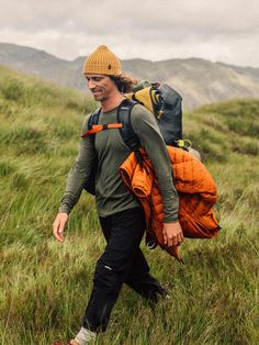 a man with a backpack walking up a hill