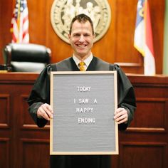 a judge holding up a sign that says today i saw a happy ending in front of him