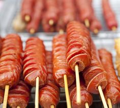 several sausages on sticks with toothpicks sticking out of them