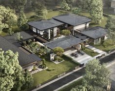 an aerial view of a large house with lots of trees and grass on the ground