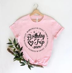 a pink birthday t - shirt with the words happy birthday trip on it and a plant