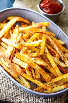 french fries in a bowl with ketchup on the side