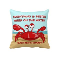 a blue pillow with an image of a crab on the beach saying everything is better when on the water even being craby