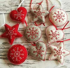 red and white ornaments hanging from strings on wooden surface