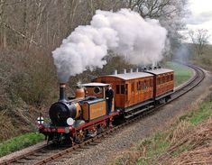 an old fashioned steam train traveling down the tracks