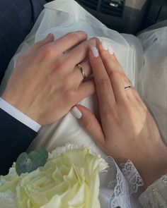 the bride and groom are holding each other's hands