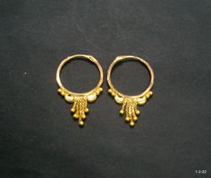 Vintage 18kt gold earrings earring pair from rajasthan india. great handmade design good for jewelry collection. It can be wear in nose as well. Note - please check pictures carefully for more details. Size - 2.8/1.8 cm. Weight - 1.960 grams. Metal - 18kt yellow gold. Round Tilla Earrings For Puja, Traditional Festive Brass Hoop Earrings, Traditional Brass Hoop Earrings For Festivals, Gold Cutdana Earrings, Gold Round Cutdana Earrings, Gold Round Earrings With Cutdana, Gold Danglers With Cutdana, 22k Gold Cutdana Earrings, 22k Gold Tilla Temple Earrings