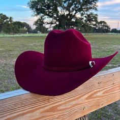 This fur blend 4X hat comes in our traditional 4 3/4" Cattleman crown, a nicely shaped scoop front 4" brim, finished with a self felt band with a silver buckle set. The Lightning 4X is fully lined and has a leather comfort sweatband.The Lightning 4X is a long oval Cattleman crown. Brim - 4" Crown - 4 1/2" Color - Port/Burgundy 4X Wool and Fur blend 90% Wool, 10% Angora Rabbit Made in the USA Felt Cowboy Hat, Country Fits, Rabbit Colors, Felt Cowboy Hats, Angora Rabbit, The Lightning, Cowboy Hat, Cowboy Hats, Wool Blend