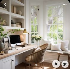 a home office with white walls and wooden flooring, along with a window seat