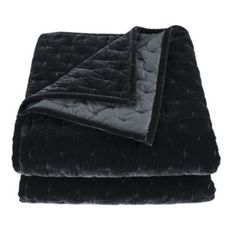 the black blanket is folded up on top of it's own bedding set