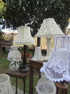 several white lamps are on display in the yard