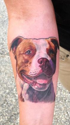 a man's arm with a dog portrait on it