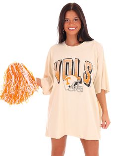 Get your game on with the Vols Helmet Fade Oversized Tee! This officially licensed shirt gives you an old school look while showing your love for the University of Tennessee. With a quirky style and playful tone, this tee is perfect for any true fan. Go Vols! Oversized Fan Apparel Tops For Game Day, Oversized Cotton Tops For School Spirit, Retro Oversized T-shirt For College, Oversized Collegiate T-shirt For Game Day, Oversized Game Day T-shirt With Screen Print, Retro Oversized Tops For Game Day, Oversized Retro Top For Game Day, Oversized Pre-shrunk T-shirt For Game Day, Oversized Screen Print Fan Merchandise Top