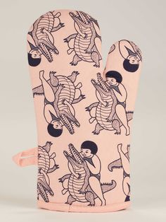 the oven mitt has an image of alligators on it, and is pink with black